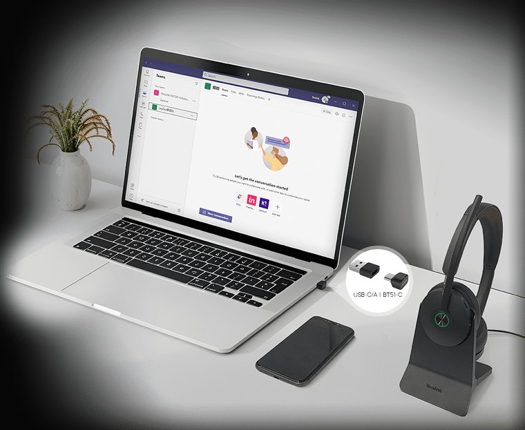 Yealink BH74 headset beside a laptop running Microsoft Teams